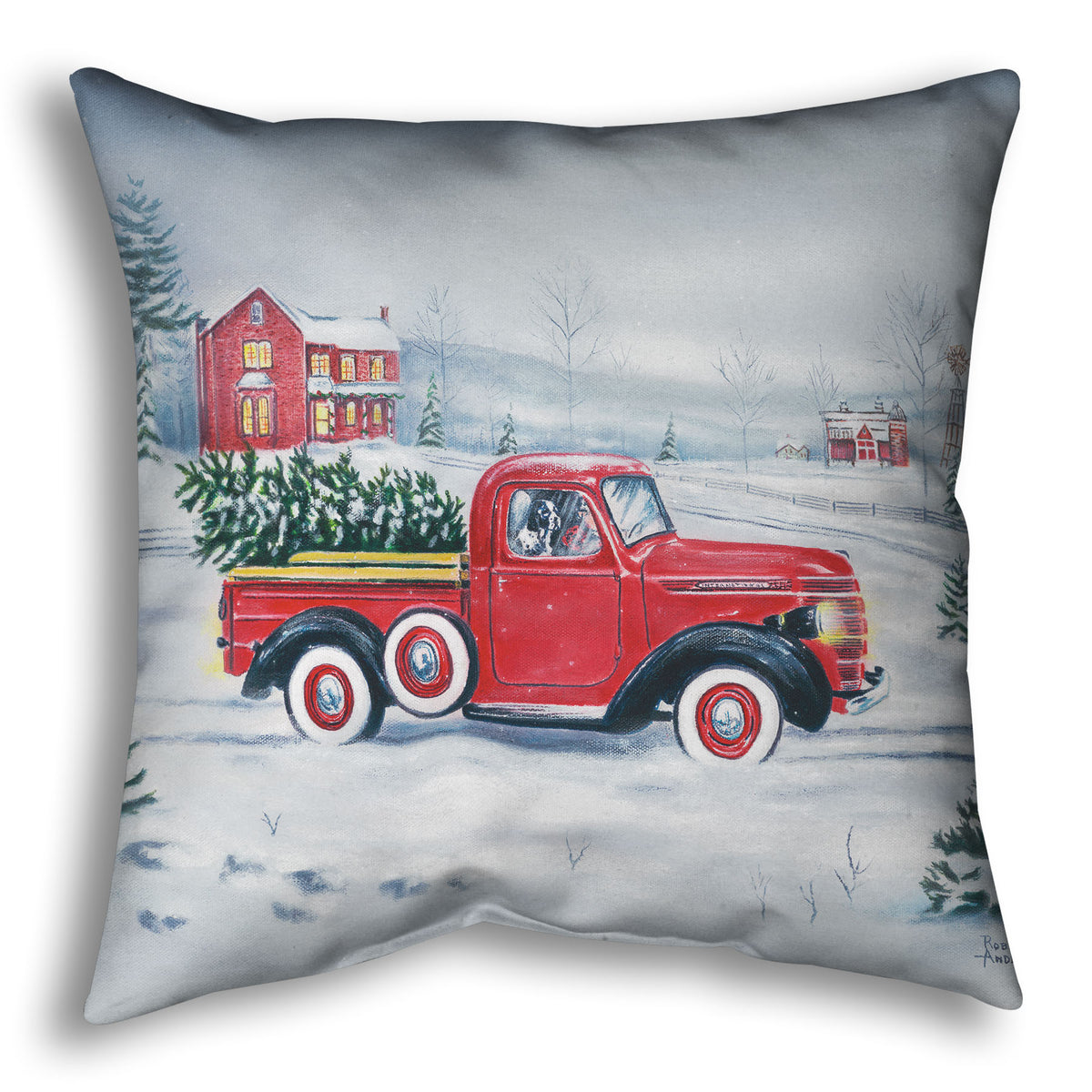 Decorative pillow printed with a red truck and Christmas tree driving through a snowy landscape.