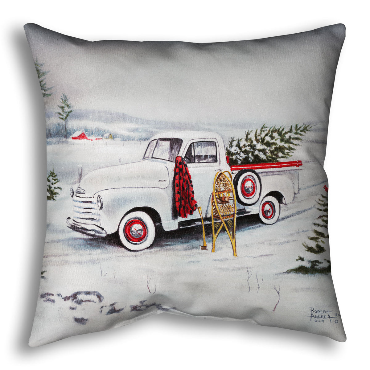 Decorative pillow designed with a truck carrying a christmas tree through a snowy scene.