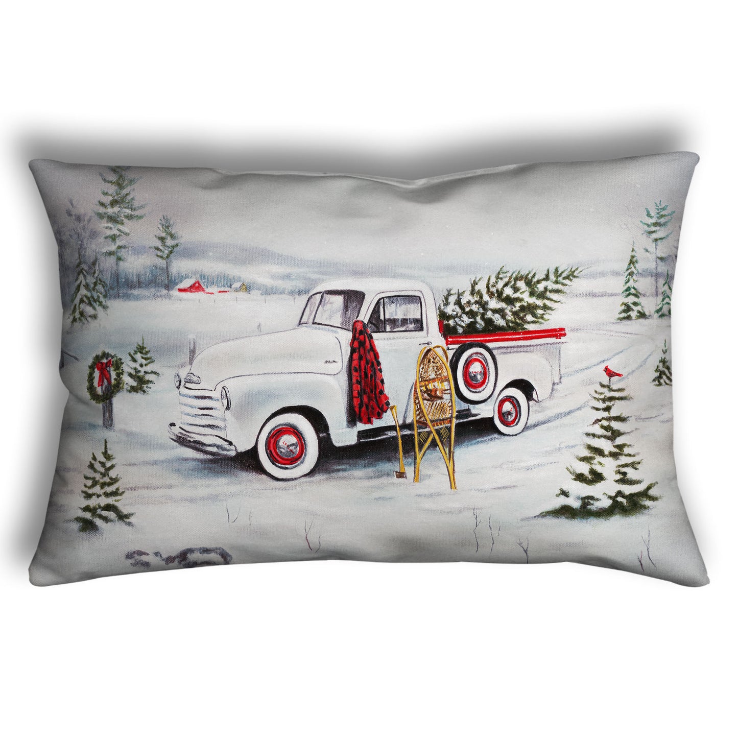 Decorative pillow designed with a truck carrying a christmas tree through a snowy scene.