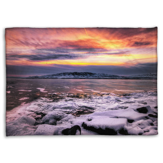 A coral fleece blanket designed with the photo of a sunset over an icy lake at Mount Timpanogos, Utah, one Christmas evening.