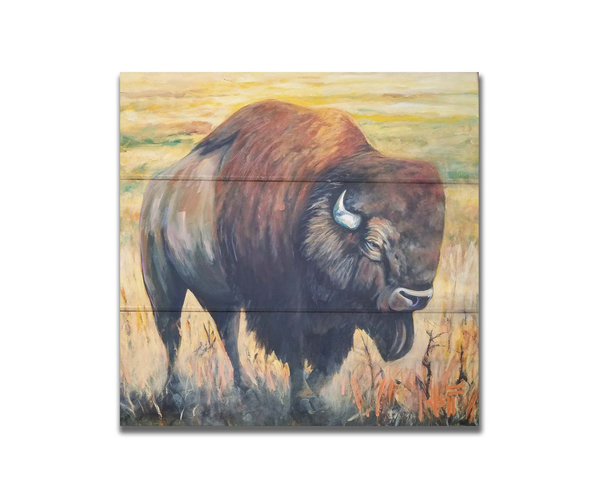A painting of an American bison, standing in a light yellow field. Printed on a box board.