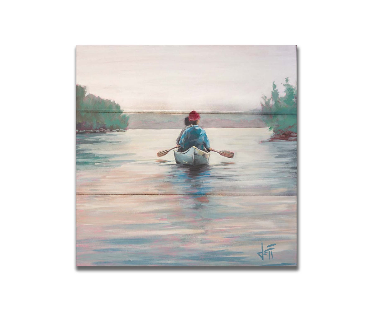 A painting of two people paddling a canoe across a lake in the early morning. The sky is pale reflecting on the water, and green trees line the shore along the lake. Printed on a box board.