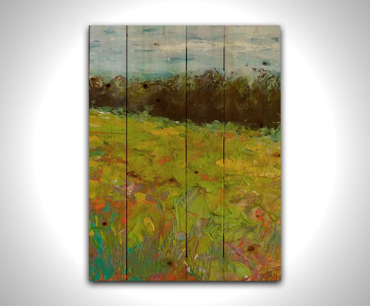 A landscape painting of a colorful meadow bordered by a lush forest, created using vibrant green impasto with pops of orange, pink, yellow, and blue. Printed on a wood pallet.