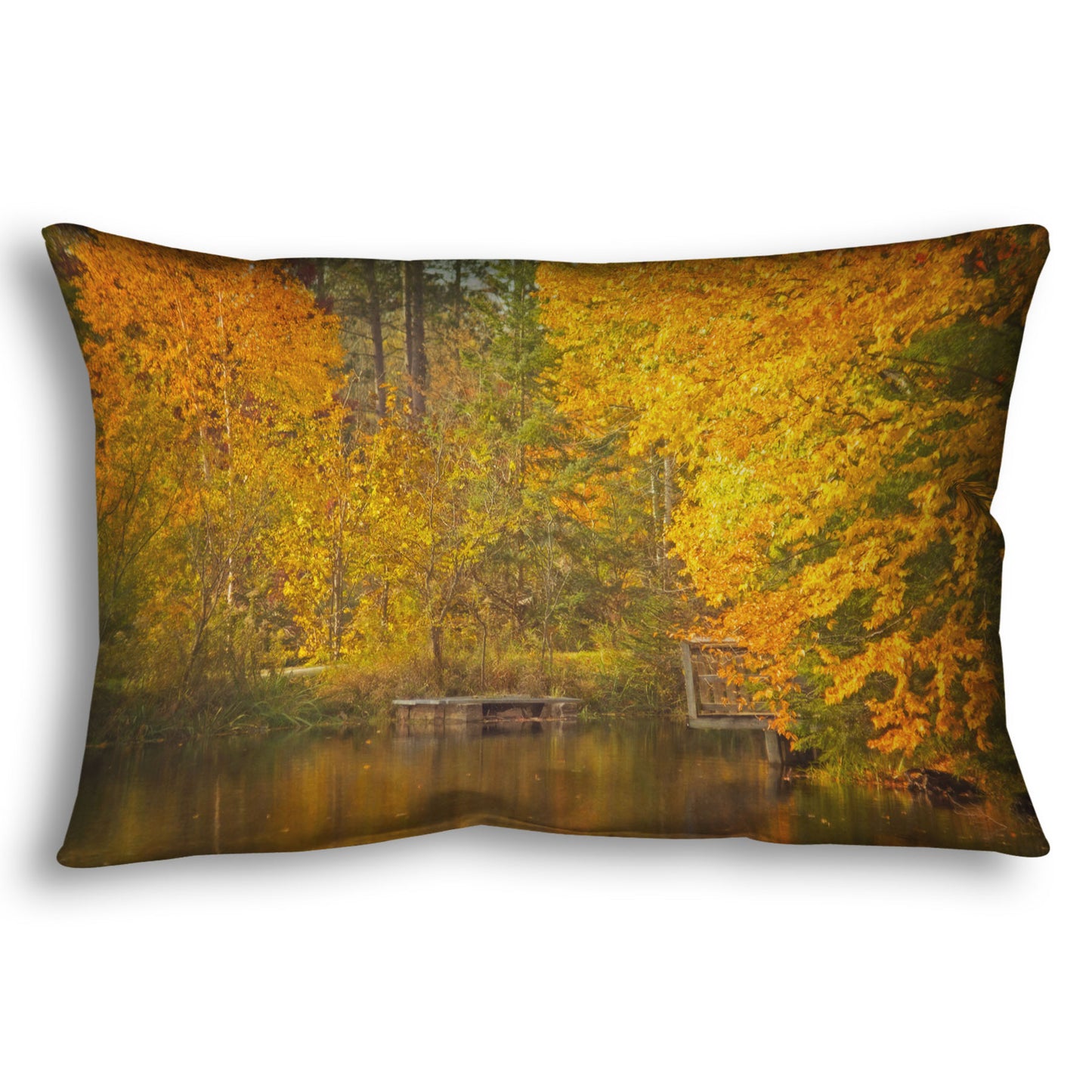 A throw pillow designed with a photo of yellow autumn trees at a pond, their leaves reflecting off the water.