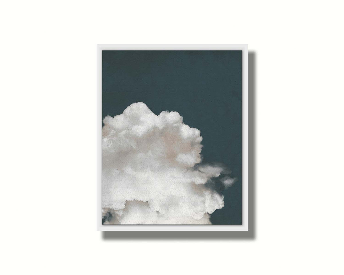 An edited photo of a fluffy white cloud against a deep navy blue background. Printed on canvas in a float frame.