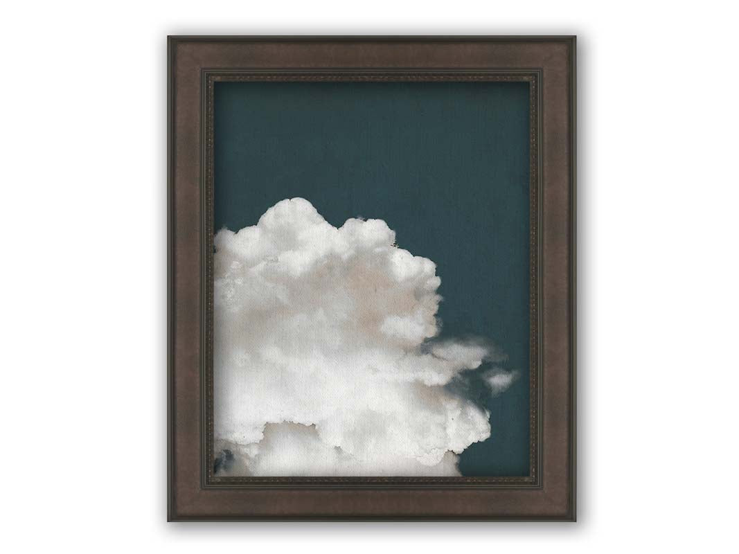 An edited photo of a fluffy white cloud against a deep navy blue background. Printed on canvas and framed.