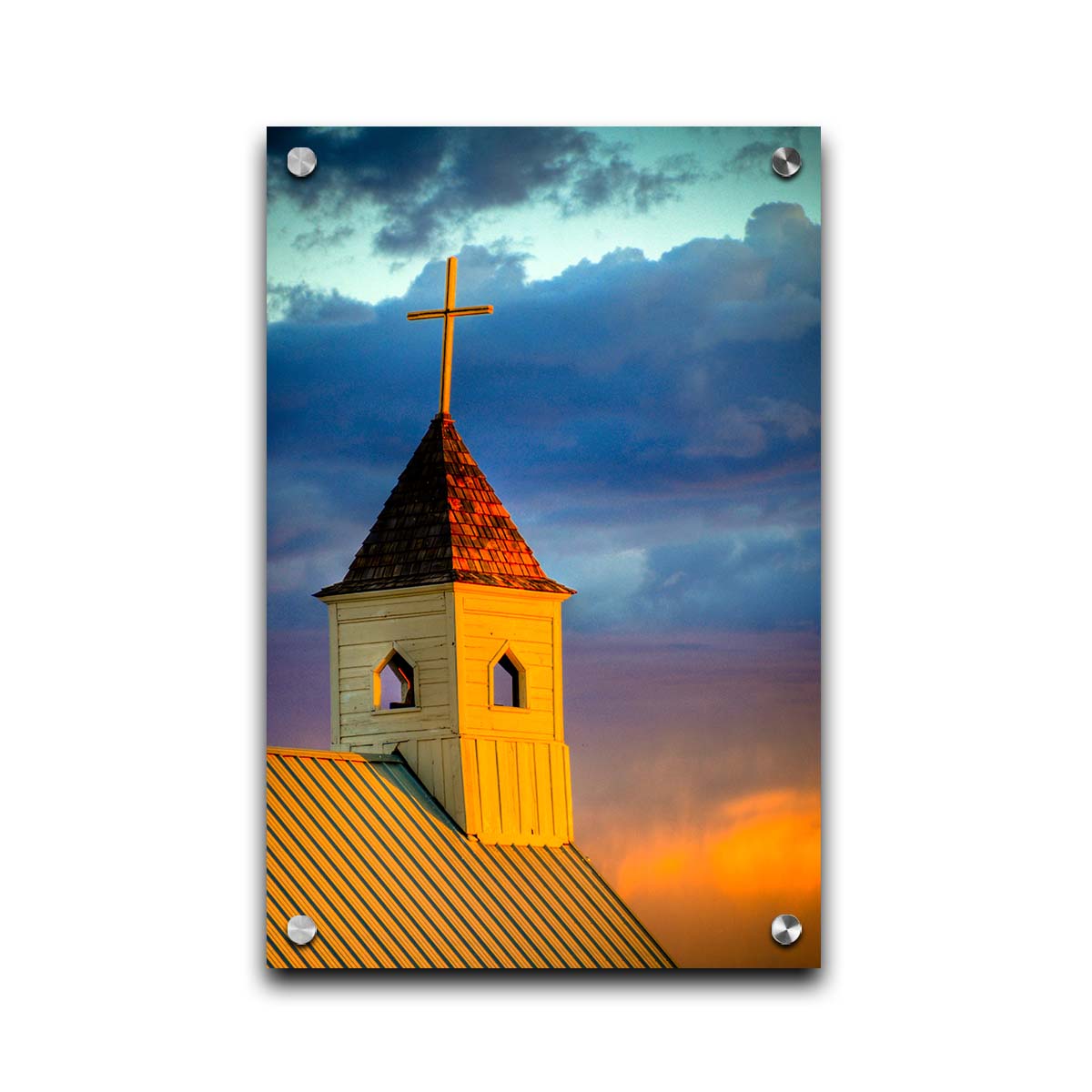 A photo of a cross-topped church at sunset, the sky gradating from blue to purple to orange. Printed on acrylic.
