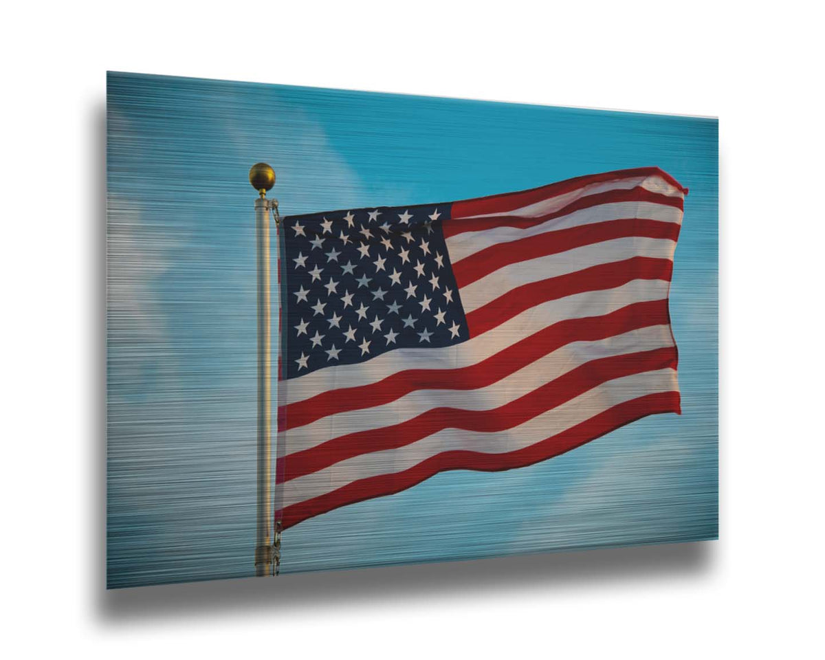 A photo of an American flag against a bright blue sky. Printed on metal.