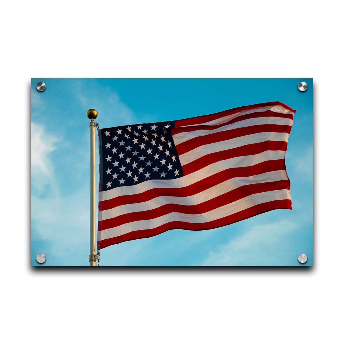 A photo of an American flag against a bright blue sky. Printed on acrylic.