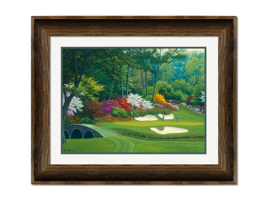 A painting of the Augusta Nationals golf course in Georgia. The course is encircled by foliage and flowers of all colors, and a bridged stream runs through the center. A few golfers stand near a small sand pit, lining up a shot to the nearby hole. Printed on paper, matted, and framed.