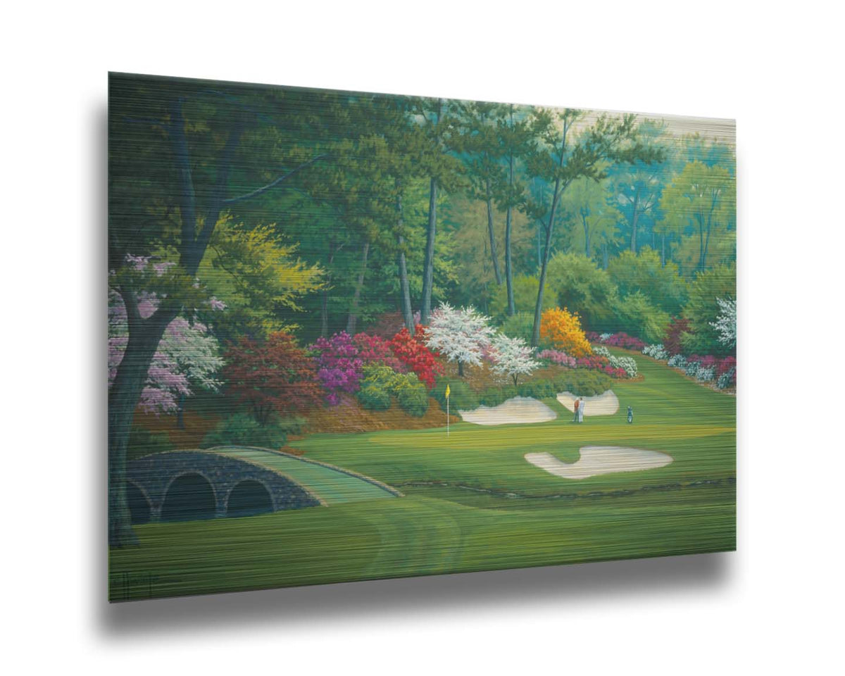 A painting of the Augusta Nationals golf course in Georgia. The course is encircled by foliage and flowers of all colors, and a bridged stream runs through the center. A few golfers stand near a small sand pit, lining up a shot to the nearby hole. Printed on metal.