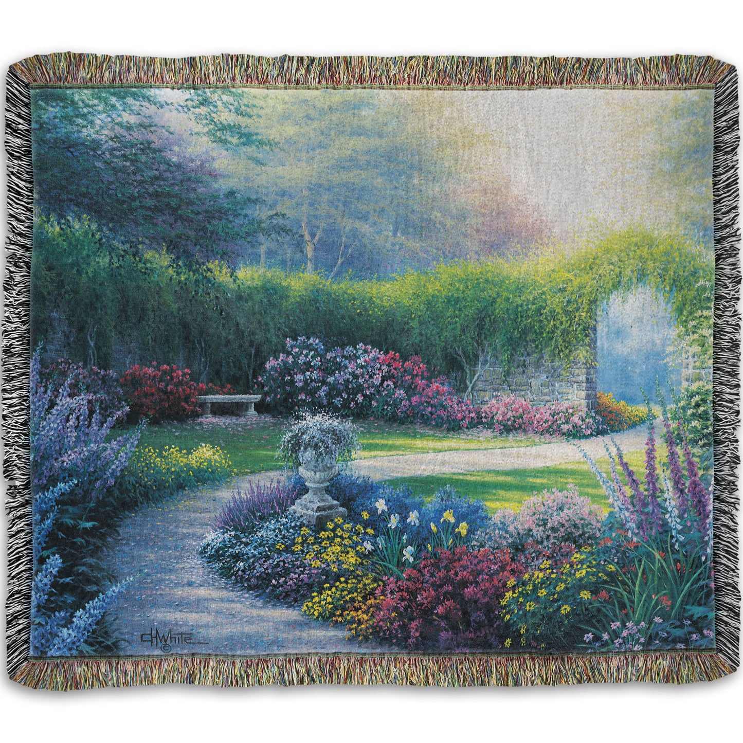 A woven blanket designed with a painting of a serene path through a garden filled with bushes of flowers bathed in a gentle light.
