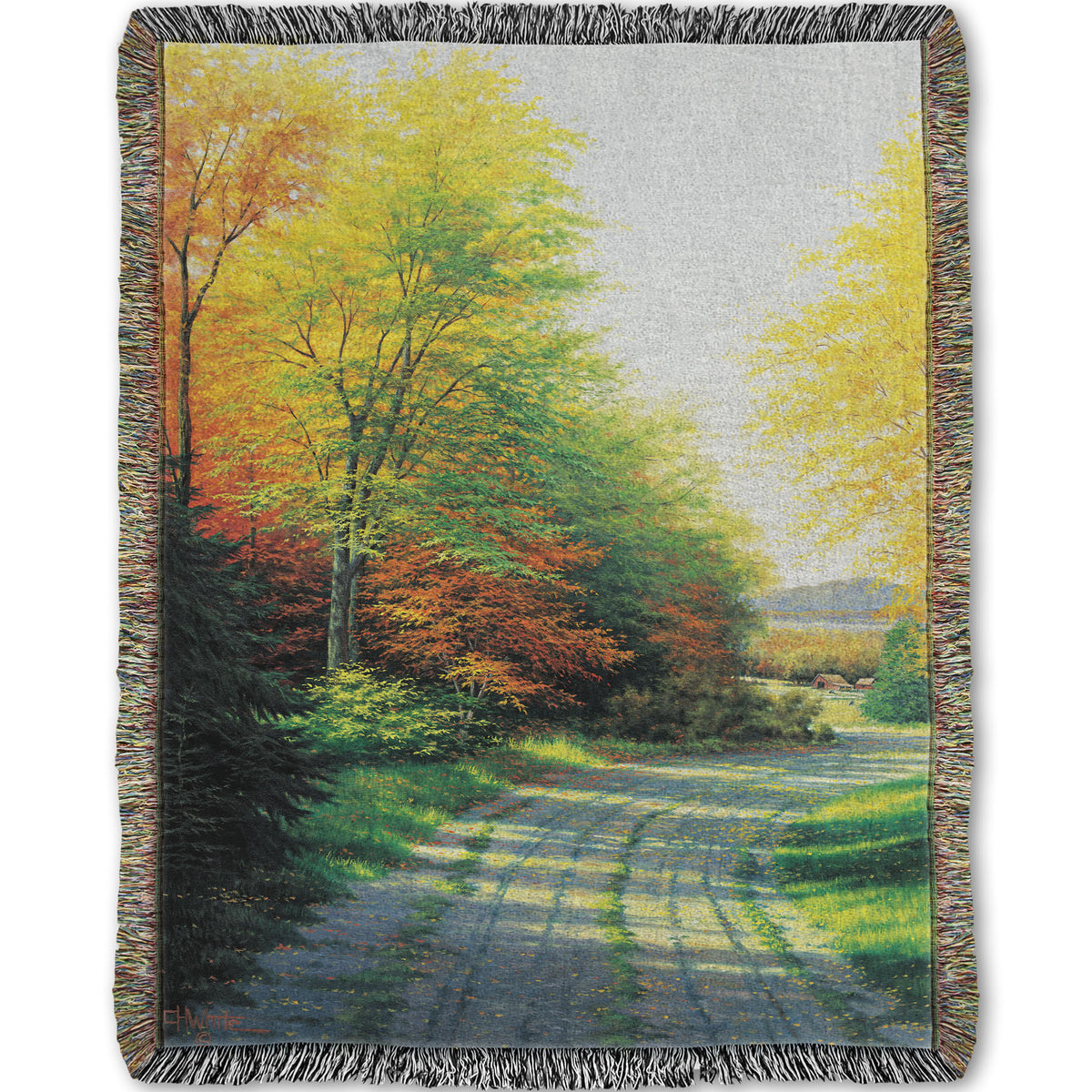 A woven throw blanket designed with a painting looking down a country road, lined with both deciduous and coniferous trees. Several of the trees' leaves have turned orange and yellow due to fall.