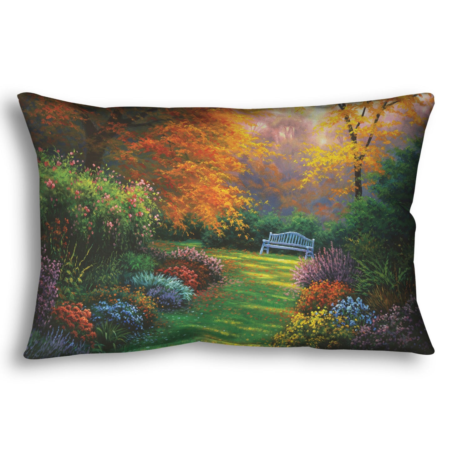 A throw pillow designed with a painting of a garden path during fall. The trees surrounding the garden have turned orange and yellow. A grassy path through the garden is surrounded by bushes of flowers in every color, and a bench can be seen up ahead.