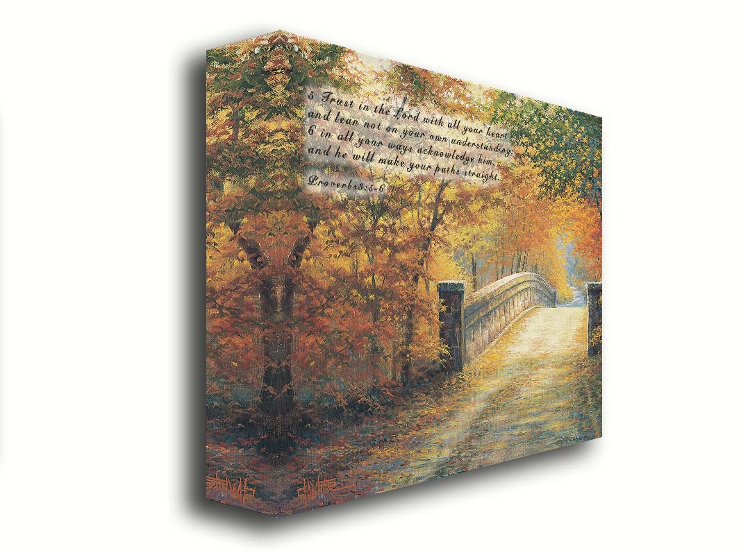 A painting looking down a bridge road during fall. The trees lining the road have turned yellow and orange for autumn, and some of their fallen leaves are scatted along the path. It is overlaid in the upper left with Proverbs 3:5-6 of the Bible, reading "5. Trust in the Lord with all your heart and lean not on your own understanding; 6. In all your ways acknowledge him, and he will make your paths straight." Printed on canvas.