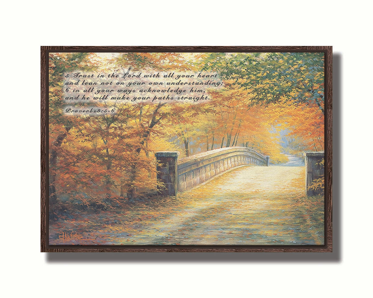A painting looking down a bridge road during fall. The trees lining the road have turned yellow and orange for autumn, and some of their fallen leaves are scatted along the path. It is overlaid in the upper left with Proverbs 3:5-6 of the Bible, reading "5. Trust in the Lord with all your heart and lean not on your own understanding; 6. In all your ways acknowledge him, and he will make your paths straight." Printed on canvas in a float frame.
