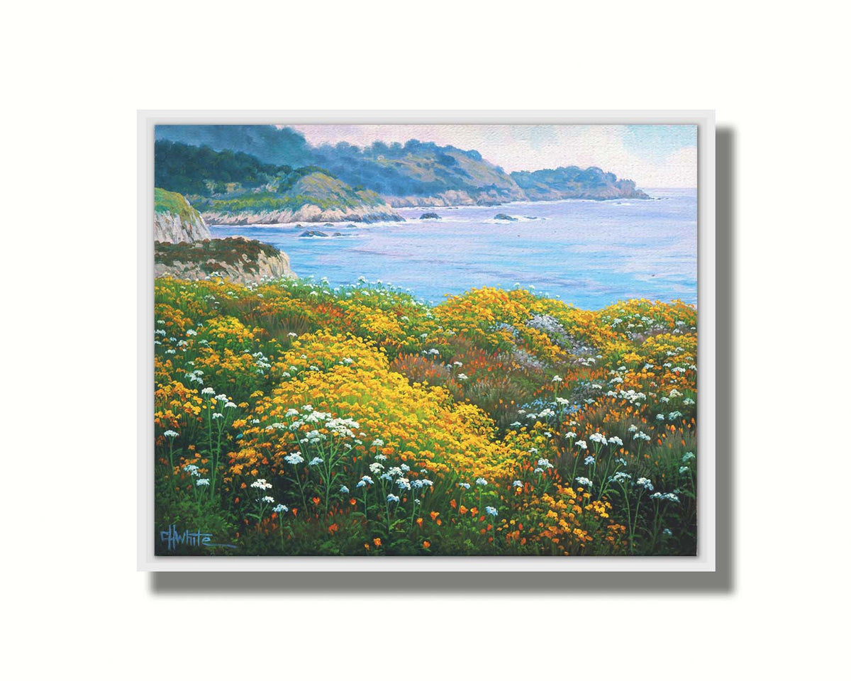 A painting of wildflowers growing in vibrant hues of yellow, white, orange, and blue, overlooking the sea from a cliff. Printed on canvas in a float frame.