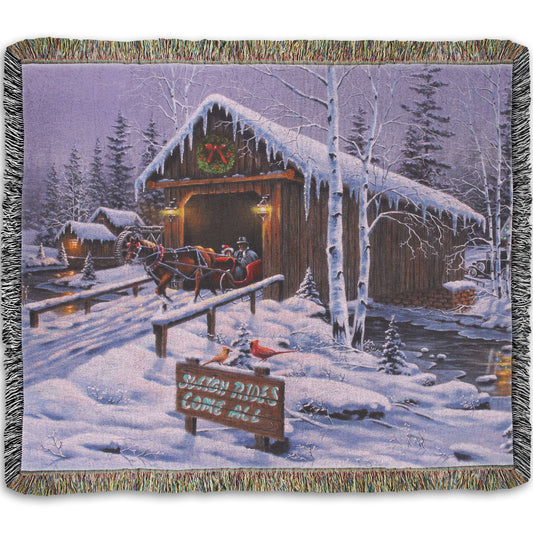 A woven throw blanket designed with a painting of people going for a ride in a horse-drawn sleigh on a snowy night.