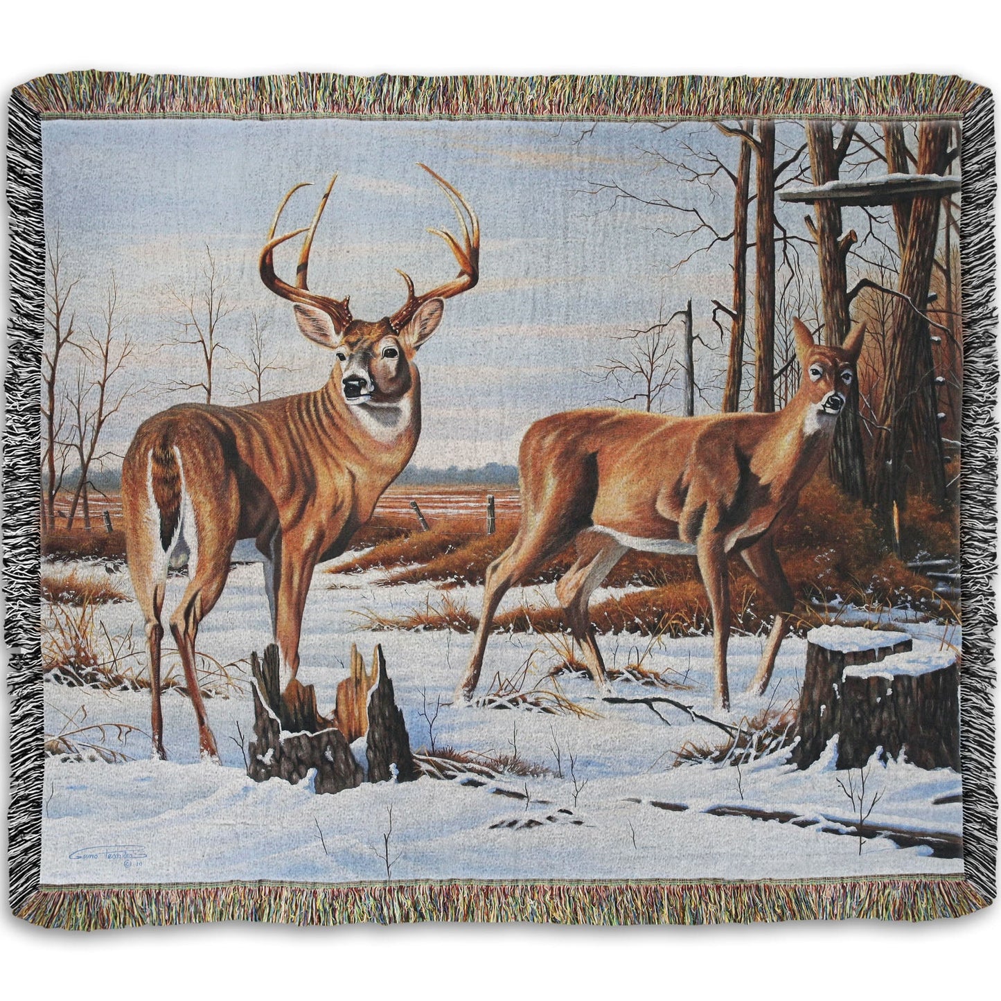 Woven throw blanket designed with deer walking through the snow between the woods and a field.
