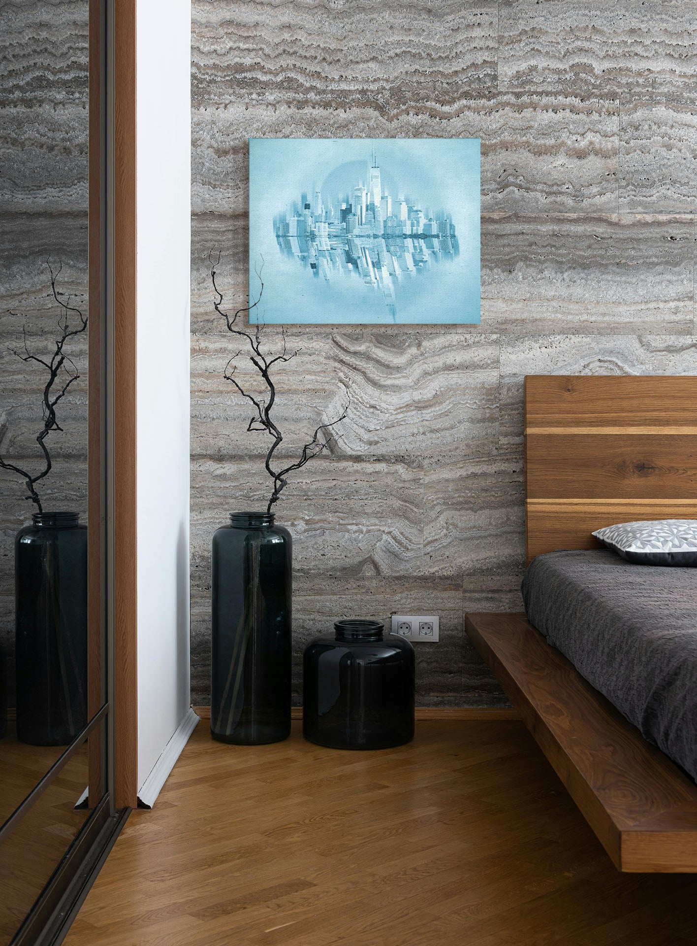 A photograph hanging on a bedroom wall. A fine art photo of the New York City skyline and its reflection, in a monochrome blue palette. Printed on canvas.