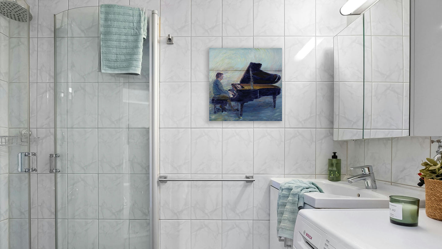 A painting hanging on a bathroom wall. A painting of a person sitting and playing piano. Printed on a box board.