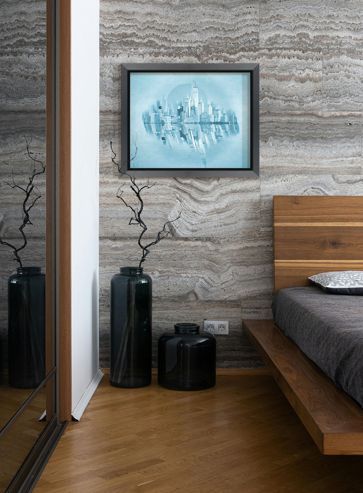 A photograph hanging on a bedroom wall. A fine art photo of the New York City skyline and its reflection, in a monochrome blue palette. Printed on canvas and framed.