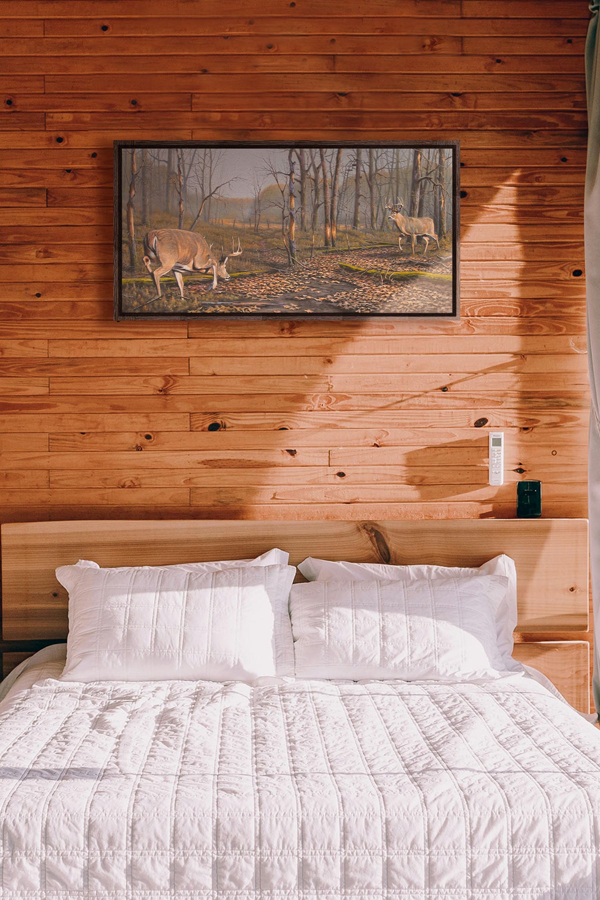 A painting hanging on a bedroom wall. A painting of two deer approaching each other in the woods. The two bucks are about to fight, as is evident by their body language. Printed on canvas in a float frame.