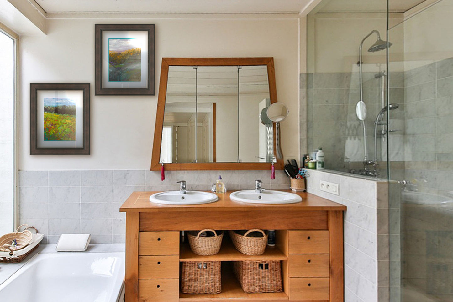Two paintings hanging on a bathroom wall. The first is a landscape painting of a colorful meadow bordered by a lush forest, created using vibrant green impasto with pops of orange, pink, yellow, and blue. Printed on paper, matted, and framed. The second is a painting of a grassy highland hillside, created with visible brushstrokes. Printed on paper, matted, and framed.