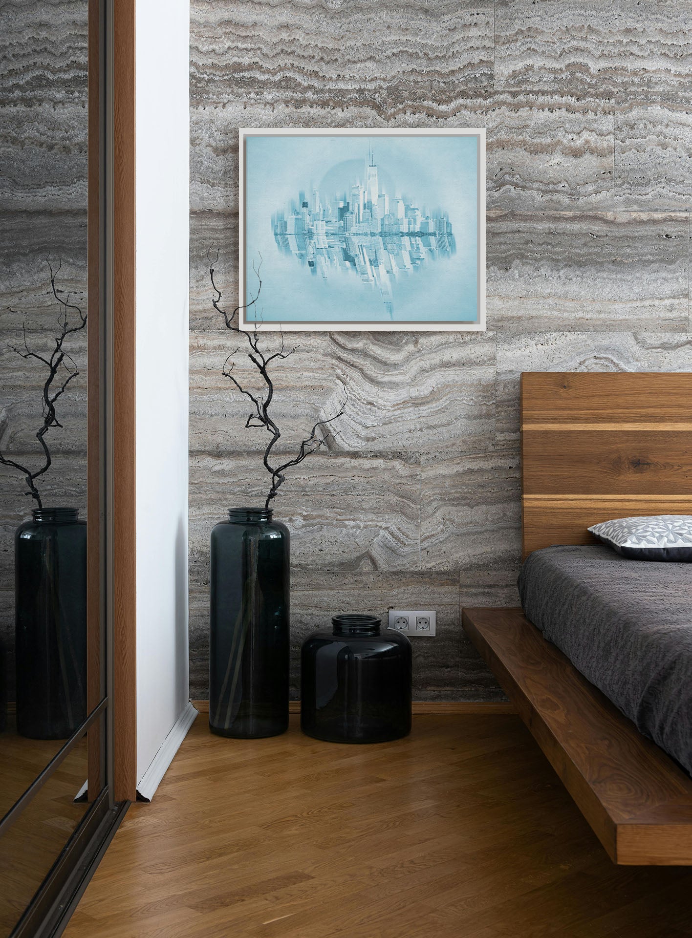 A photograph hanging on a bedroom wall. A fine art photo of the New York City skyline and its reflection, in a monochrome blue palette. Printed on canvas in a float frame.