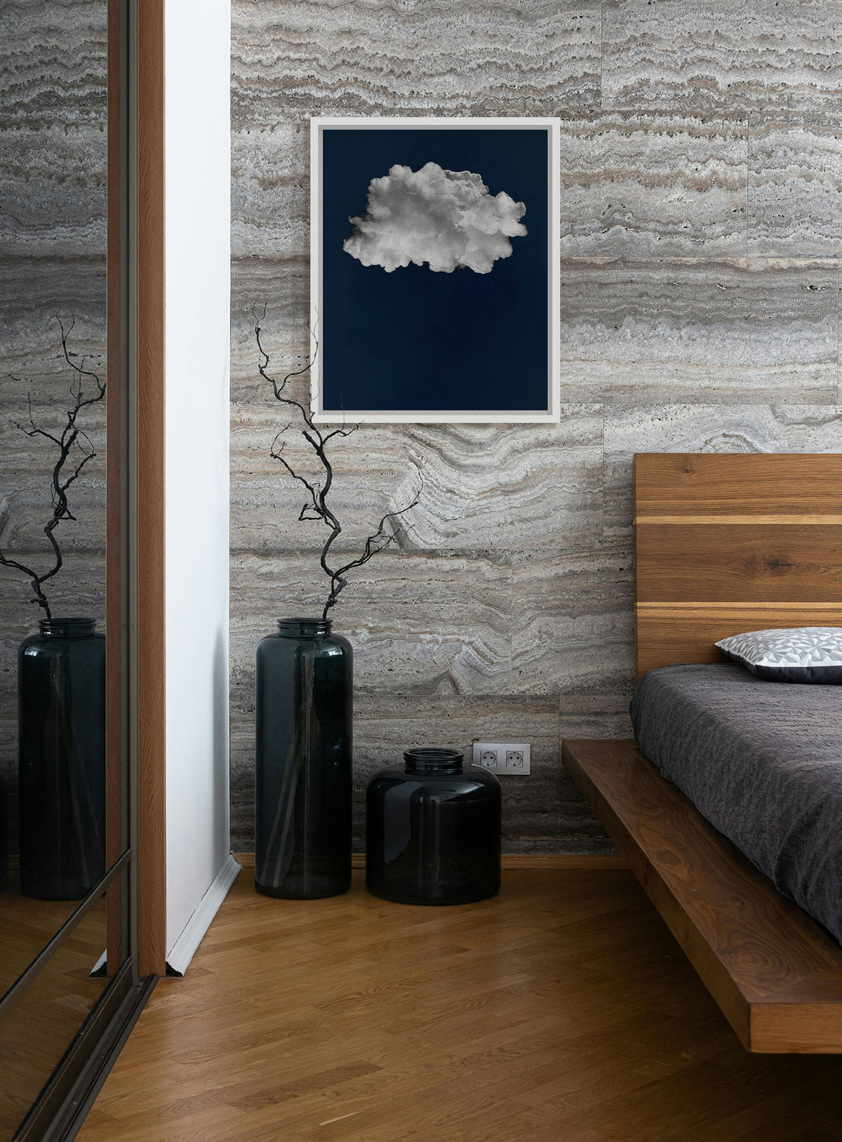 Artwork hanging on a bedroom wall. A photo edit of a large, fluffy white cloud against a deep blue background. Printed on canvas in a float frame.
