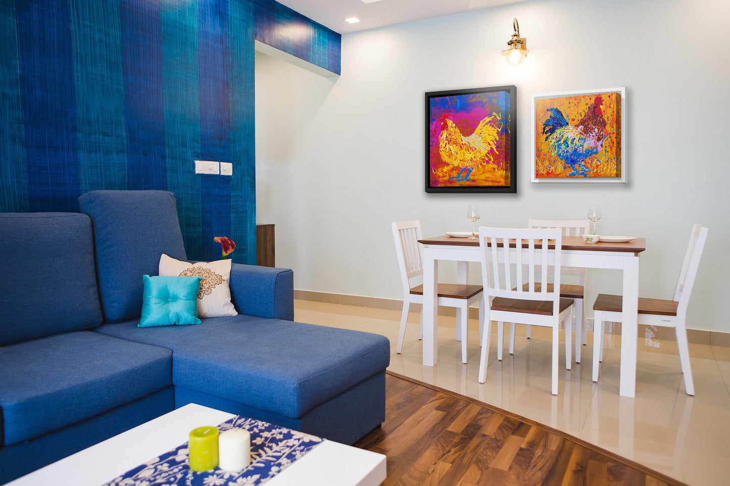 Two paintings hanging on a dining room wall. The first is a drip painting of a vibrant yellow chicken on a pink and blue background. Printed on canvas in a float frame. The second is a drip painting of a brown and blue rooster on a vibrant orange background, splattered with accents of yellow, white, and red. Printed on canvas in a float frame.
