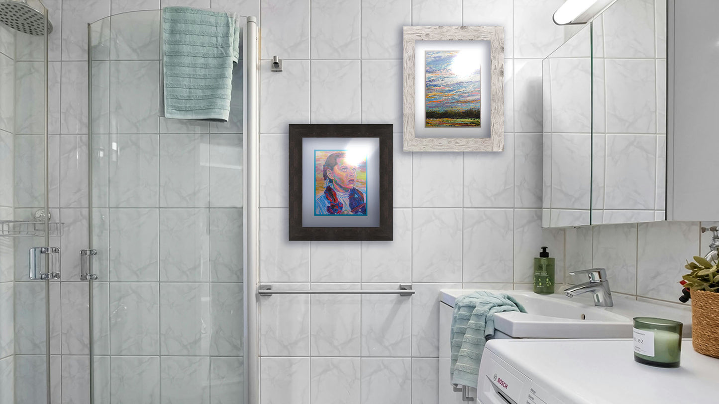 Two paintings hanging on a bathroom wall. The first is a portrait of actress Judy Garland as Dorothy in The Wizard of Oz, with loose visible brushstrokes and accents of arbitrary color inspired by post-impressionist art. Printed on paper, matted, and framed. The second is a colorful painting of the sky, using heavily textured applications of paint. Printed on paper, matted, and framed.