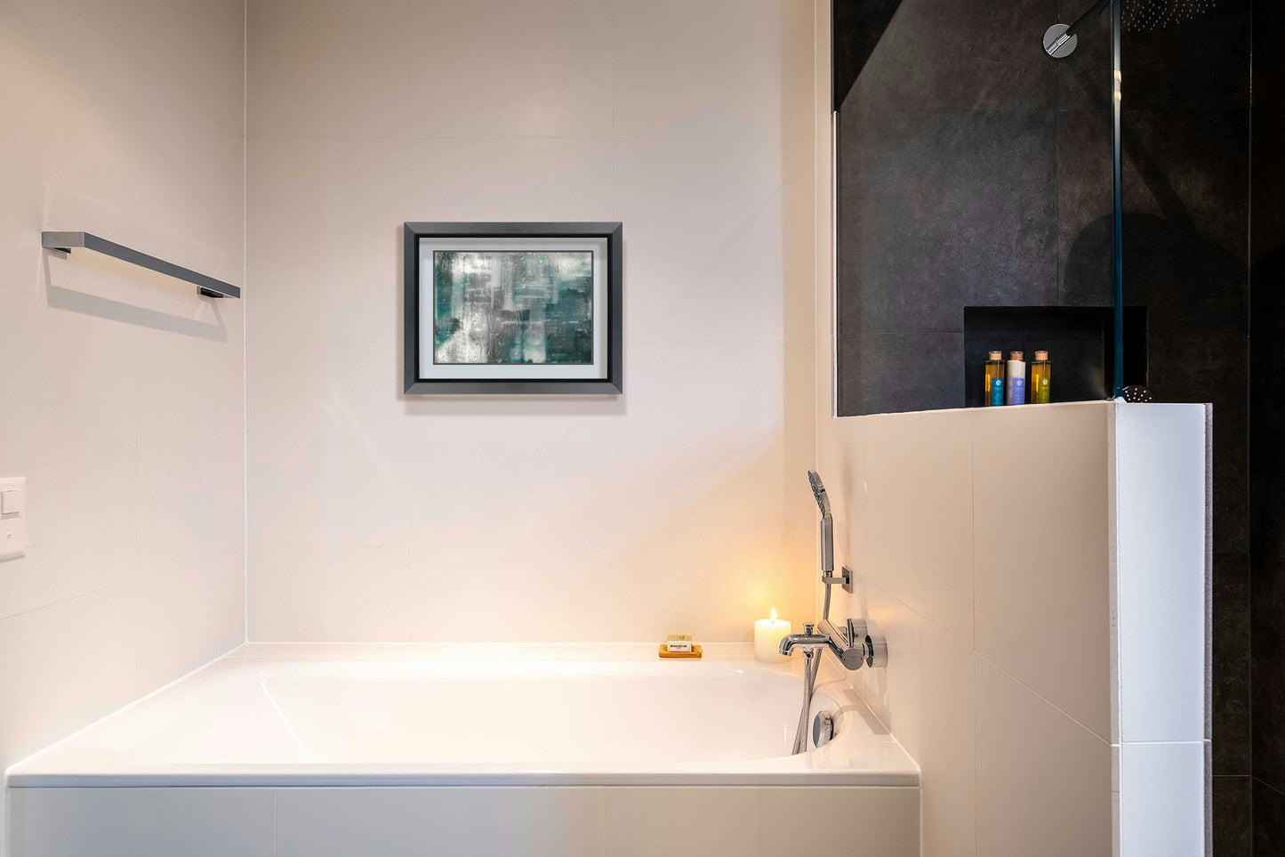 A photograph hanging on a bathroom wall. A photo looking across a city from a window, edited to have a blurry, inky quality and overlaid with rainy wet glass. Printed on paper, matted, and framed.