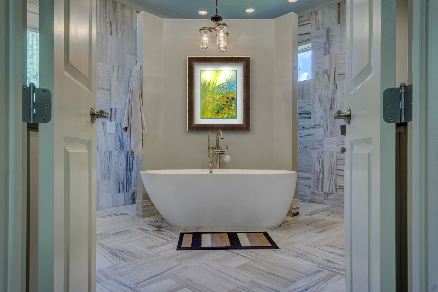 A painting hanging on a bathroom wall. A landscape painting looking down at green grasses and reeds, a bush adorned with vibrant red flowers, and a tranquil blue pond. The simplified, abstracted style focuses on color and movement. Printed on paper, matted, and framed.