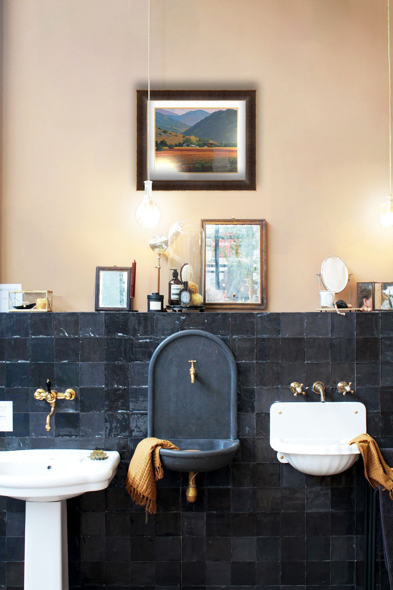 A painting hanging on a bathroom wall. A landscape painting of the Napa Valley wine region in California. Colorful orange, red, and green vineyards are nestled among forested mountains. Printed on paper, matted, and framed.
