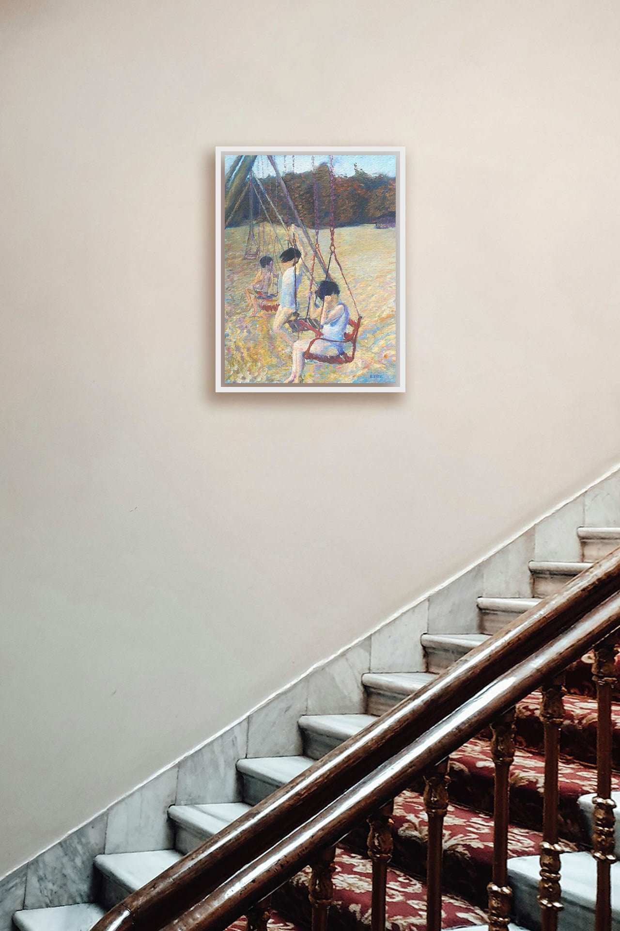 A painting hanging on a hallway wall. A painting of three children playing on the swings at a park during the fall. Printed on canvas in a float frame.