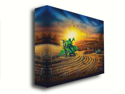 A painting of a harvester at work, gracefully cutting through fields of golden corn stalks. Geese fly overhead, illuminated by the sun on the horizon. Printed on canvas.