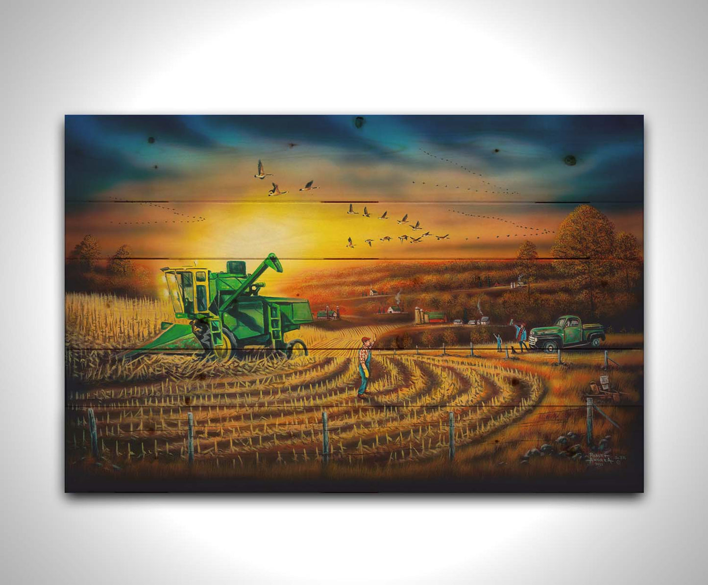 A painting of a harvester at work, gracefully cutting through fields of golden corn stalks. Geese fly overhead, illuminated by the sun on the horizon. Printed on a wood pallet.