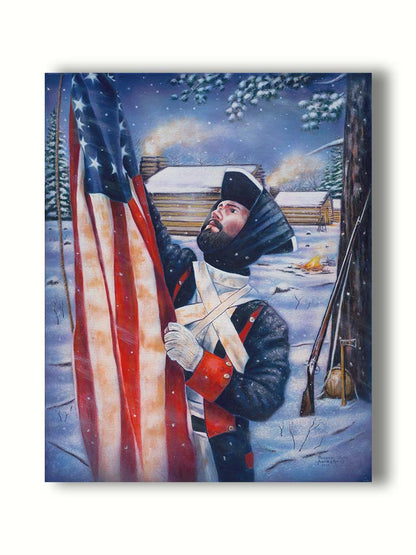 A painting of a Revolutionary War soldier raising an American flag. His musket, hatchet, and canteen rest against a tree behind him. The cabins of the fort are seen in the background. Printed on canvas.