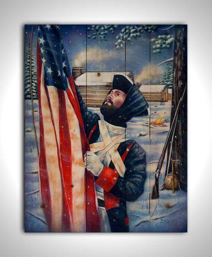 A painting of a Revolutionary War soldier raising an American flag. His musket, hatchet, and canteen rest against a tree behind him. The cabins of the fort are seen in the background. Printed on a wood pallet.