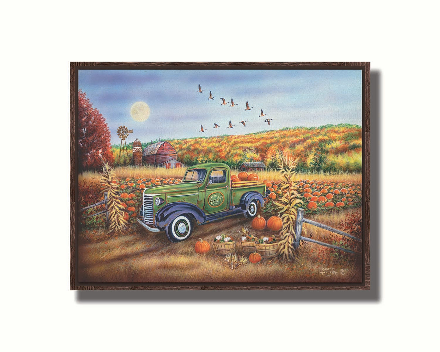 A painting of a farm, featuring a field of pumpkins and a field of corn. There is a forest of yellow, orange, red, and green fall trees in the background, and geese fly overhead. Printed on canvas in a float frame.