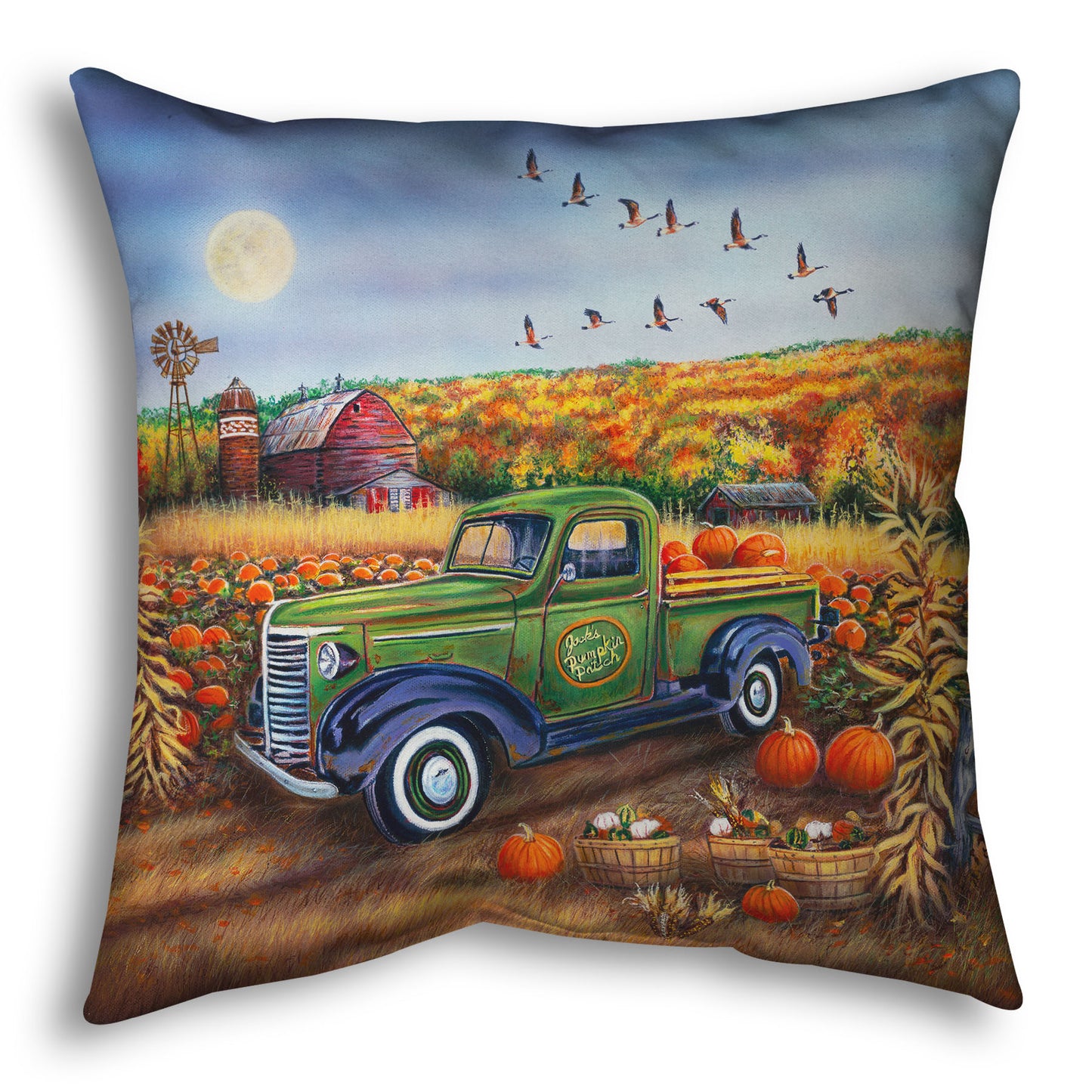 A throw pillow designed with a painting of a farm, featuring a field of pumpkins and a field of corn. There is a forest of yellow, orange, red, and green fall trees in the background, and geese fly overhead.