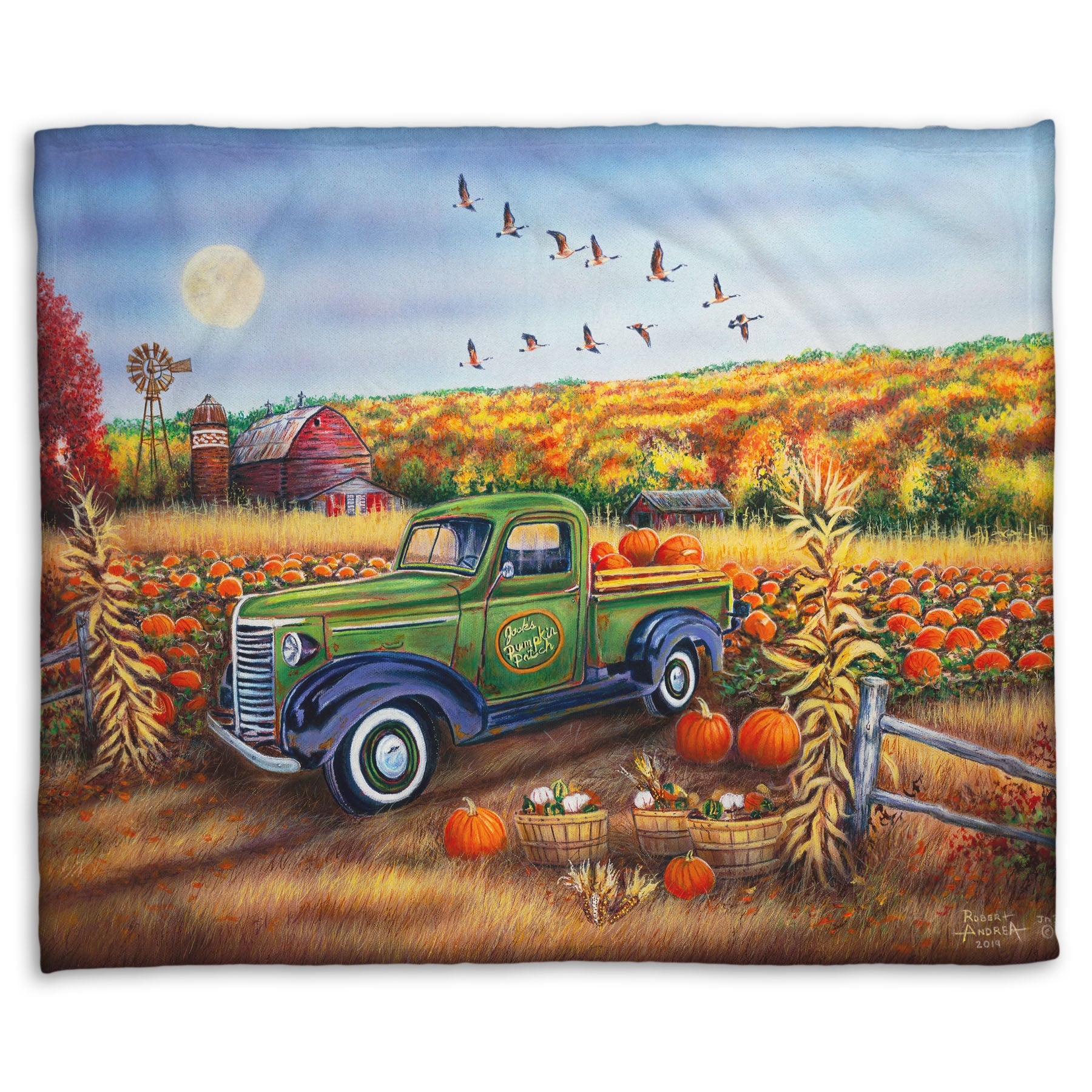 A coral fleece blanket designed with a painting of a farm, featuring a field of pumpkins and a field of corn. There is a forest of yellow, orange, red, and green fall trees in the background, and geese fly overhead.