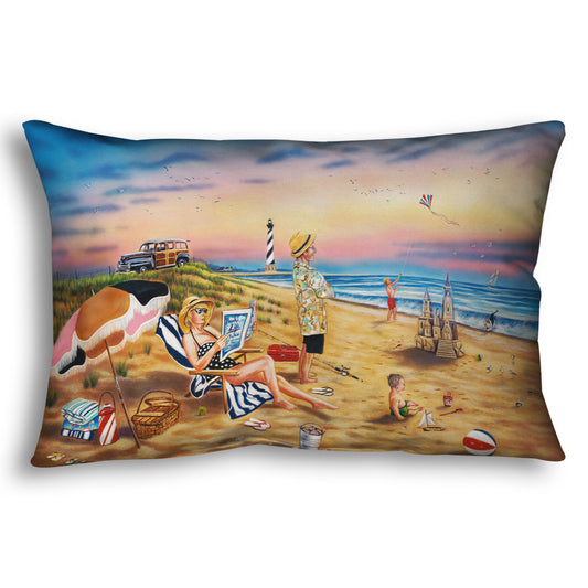 A throw pillow designed with a painting of a family vacationing on the beach. The adults relax while the children play, with one in the sand and another flying a kite with their dog.