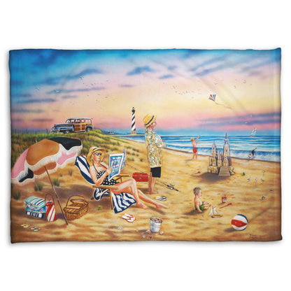 A coral fleece blanket designed with a painting of a family vacationing on the beach. The adults relax while the children play, with one in the sand and another flying a kite with their dog.
