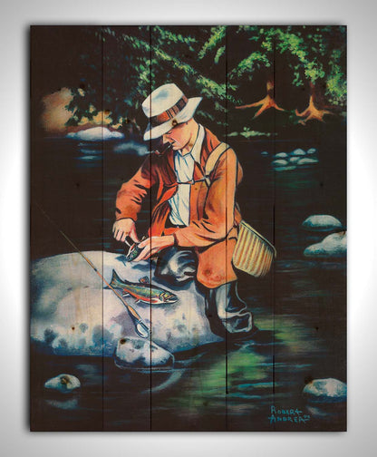 A painting of a fisherman standing in the river, cleaning a fish he just caught. Printed on a wood pallet.