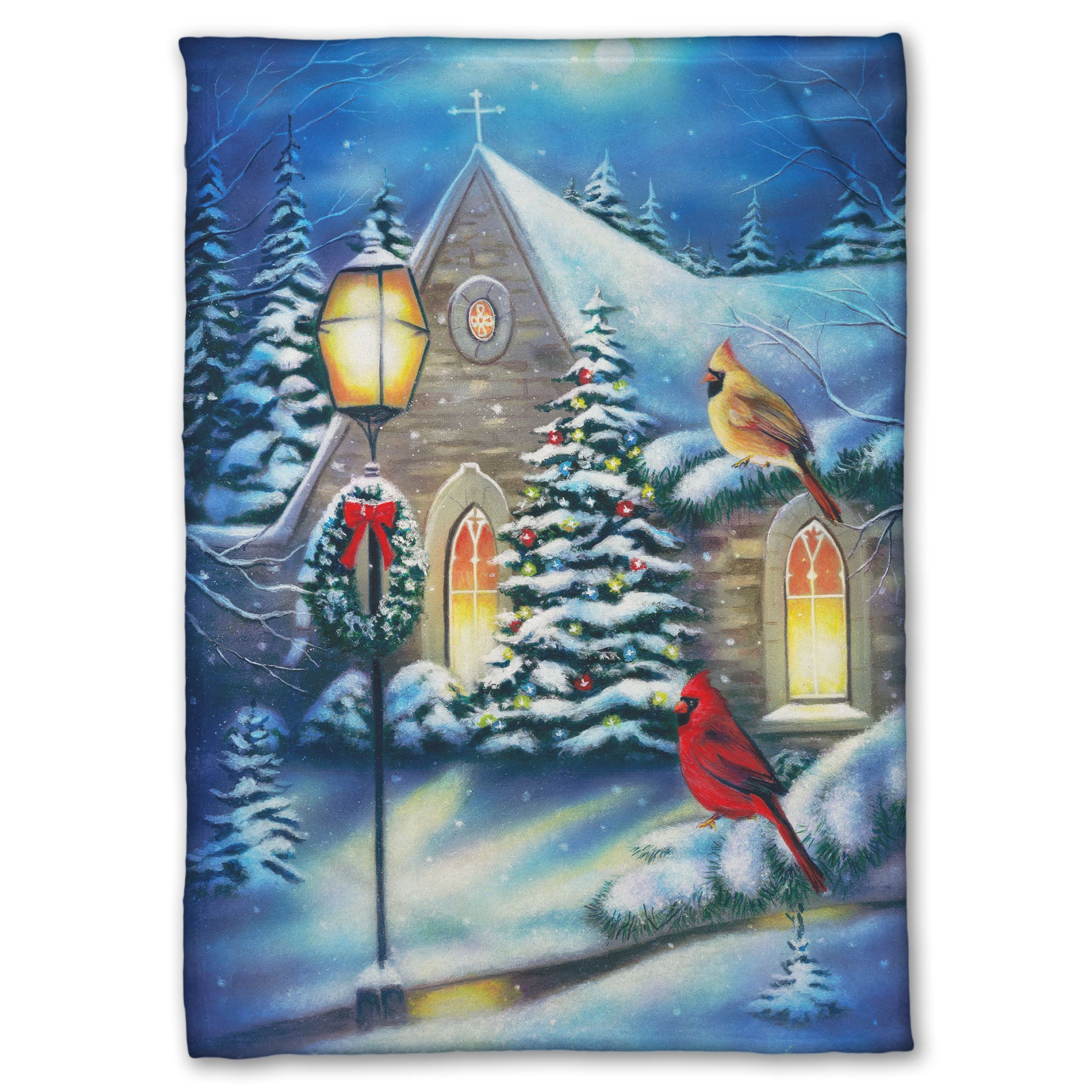 Coral fleece blanket designed with a snowy christmas scene in a church courtyard, where cardinals are perched on evergreen tree branches.