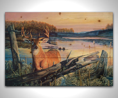 Painting of a deer in front of a lake reflecting the morning sky. Printed on a wood pallet.