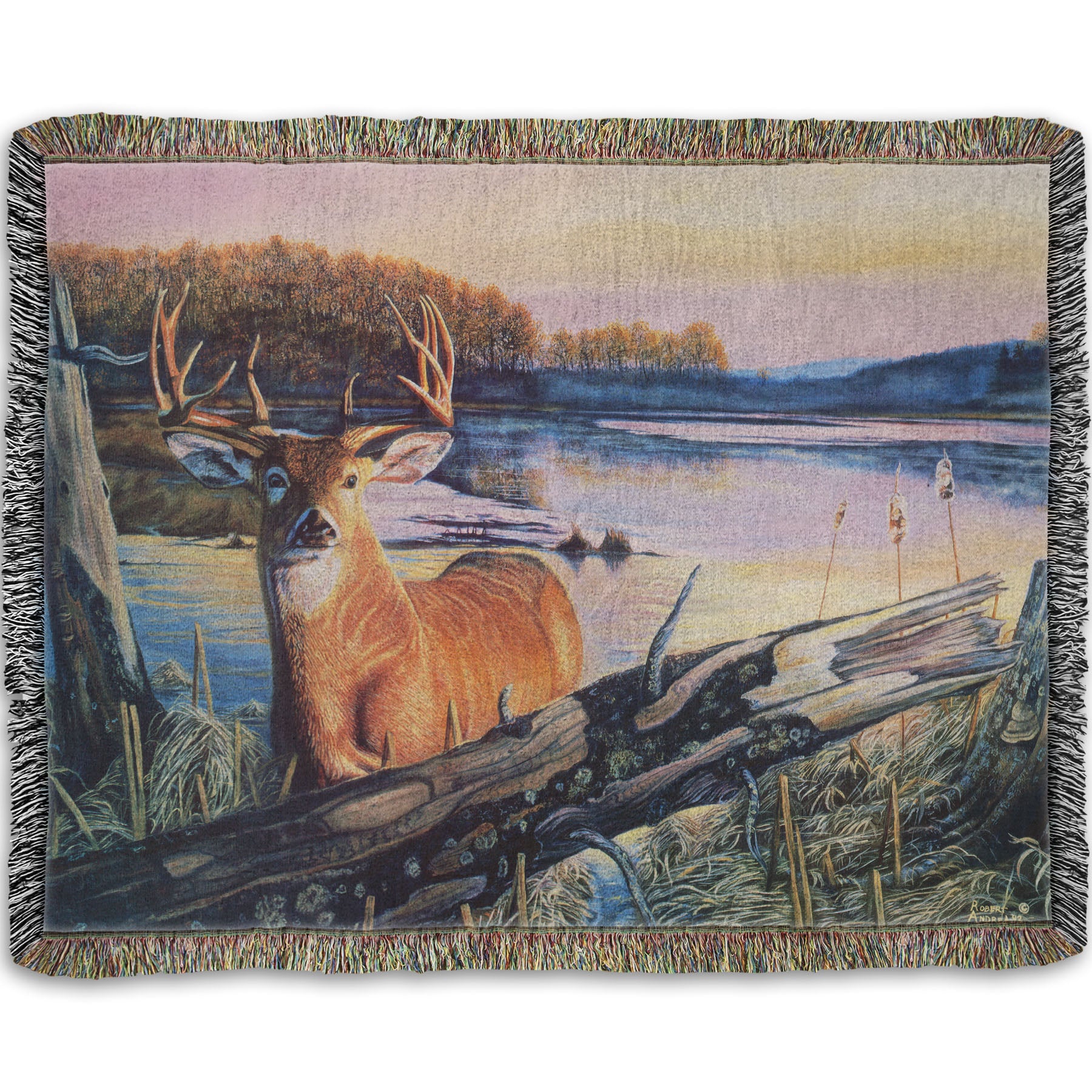 Woven throw blanket designed with a painting of a deer in front of a lake reflecting the morning sky.