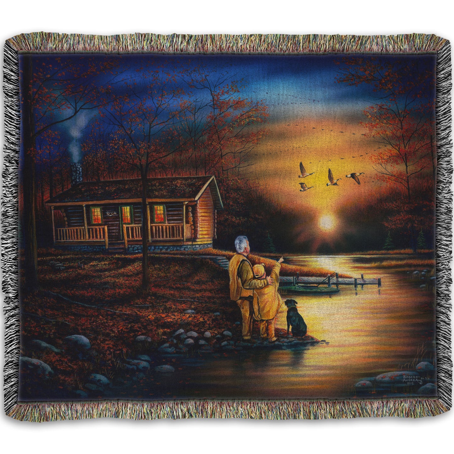 A woven throw blanket designed with a painting of a man and a child standing by a river and cabin. They are watching geese fly overhead at sunset.